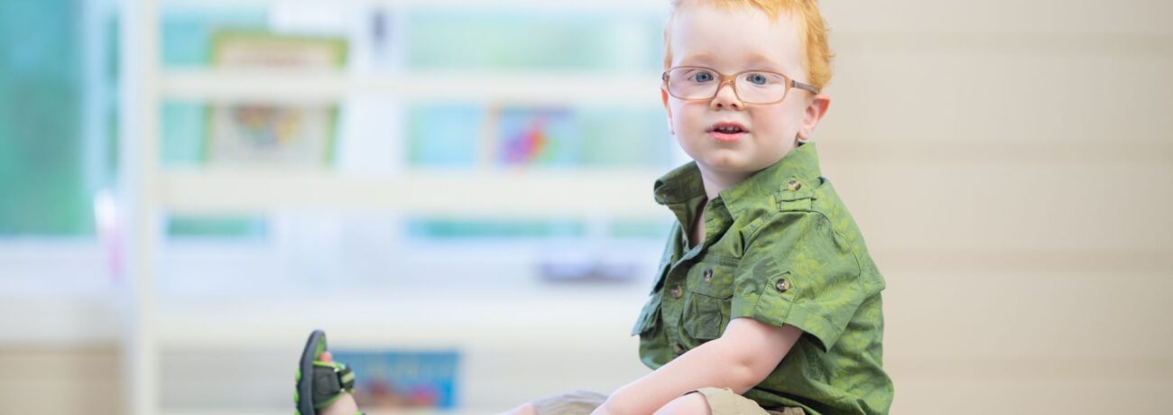 Young boy with glasses, representing masking autism.