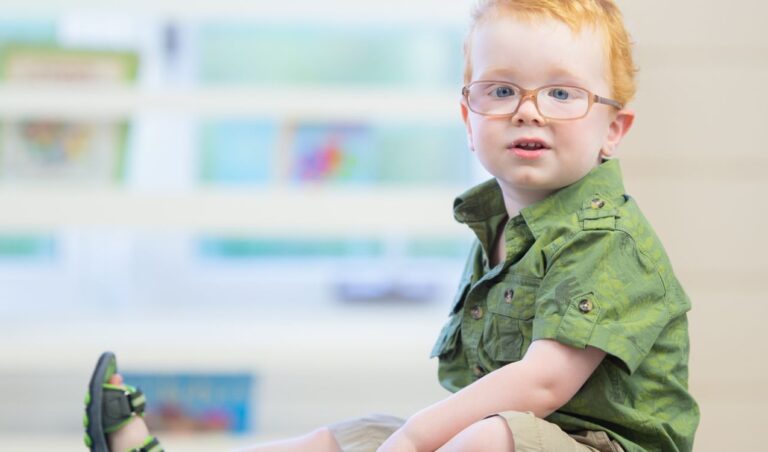 Young boy with glasses, representing masking autism.
