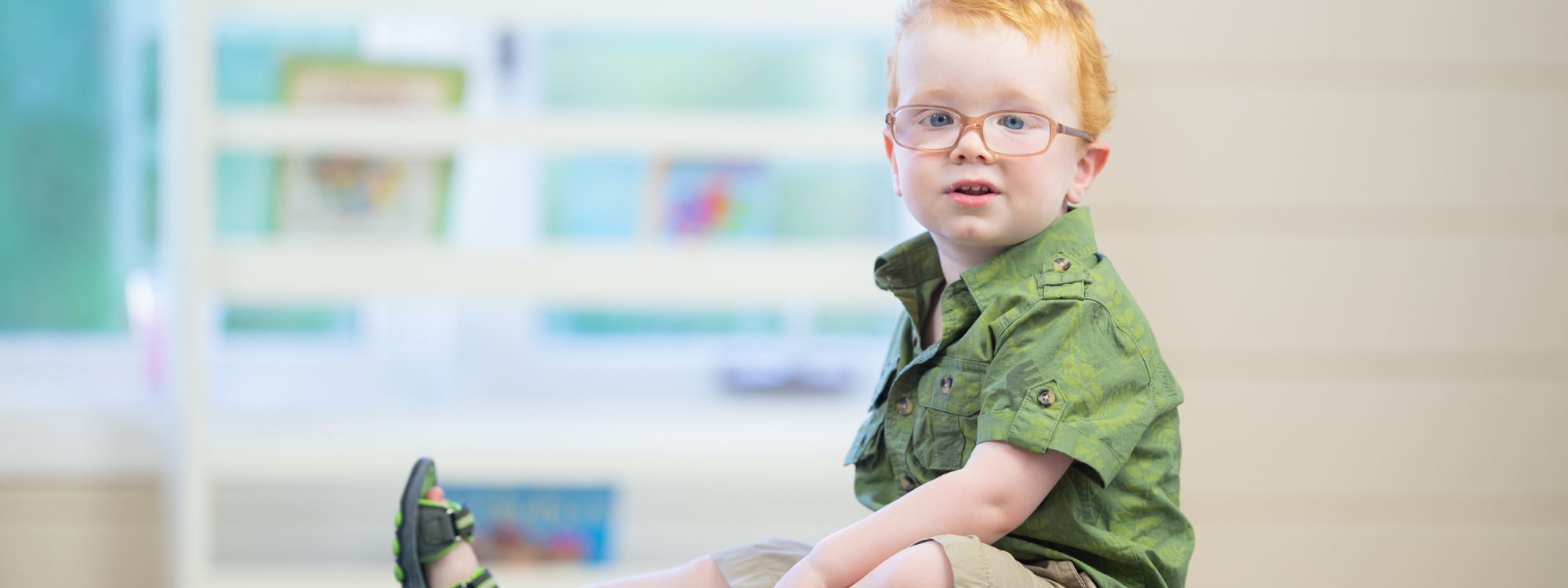 Young boy with glasses, representing masking autism.